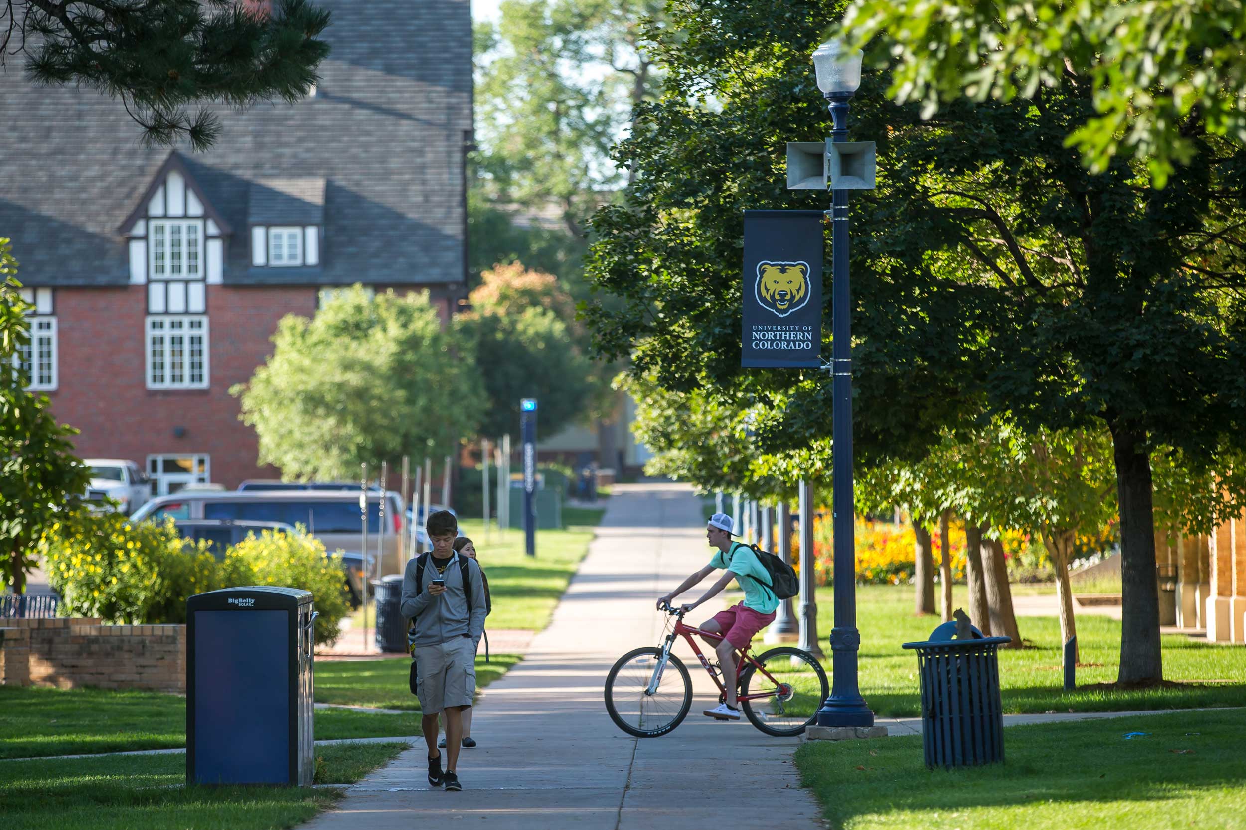 Student riding bike on campus.