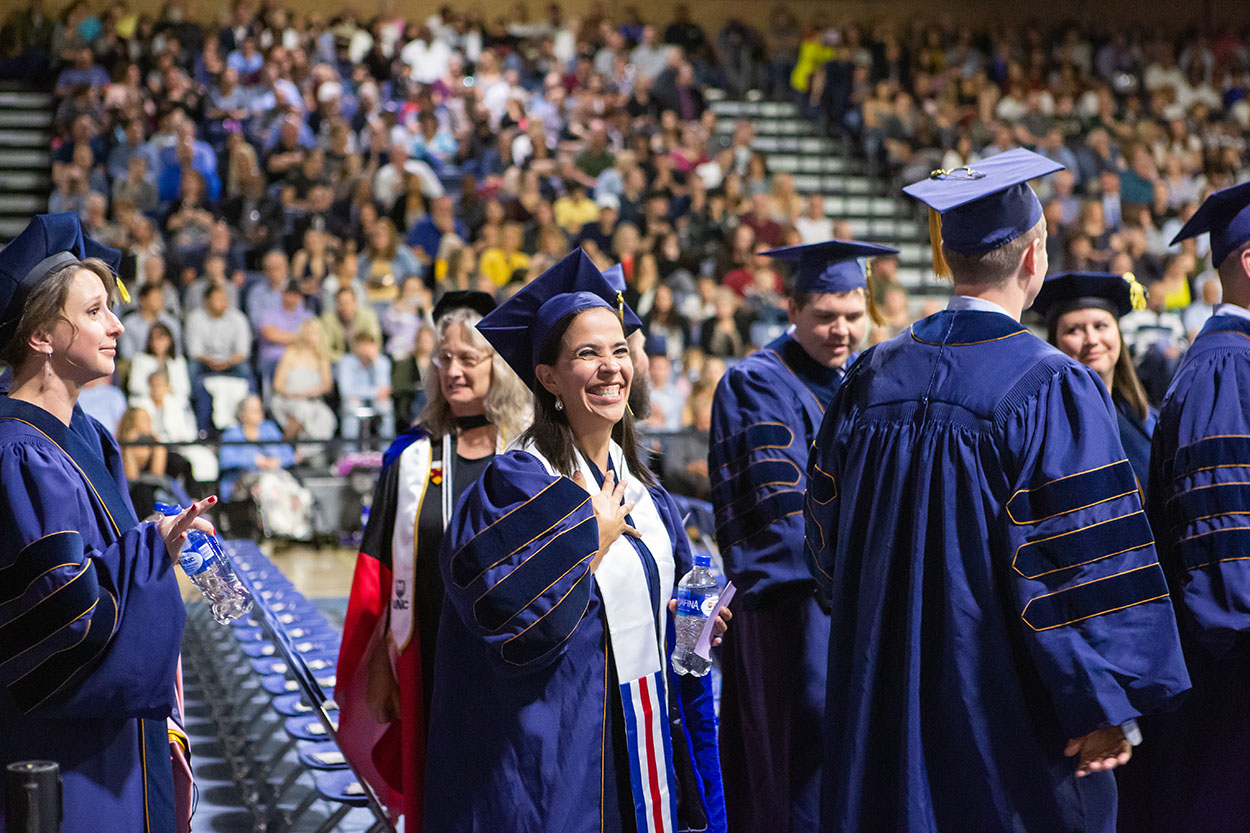 Doctoral Student smiles during commencement