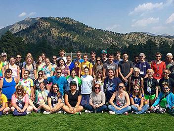 A group of Honors Students sitting in front of a mountain at YMCA, Estes Park Colorado