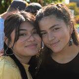 Two students smile while attending the Latinx Tailgate 2022.