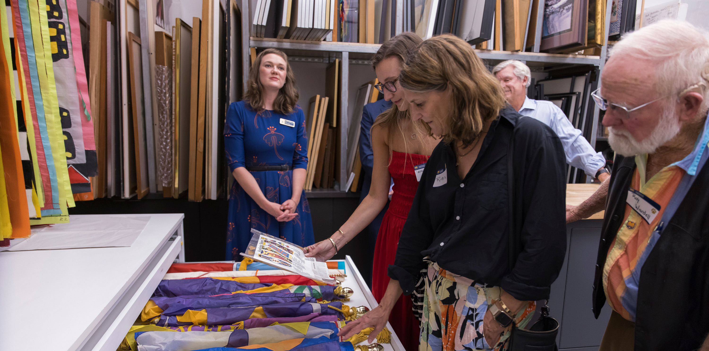 People looking at Lydia Ruyle's artwork