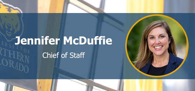 Headshot Jennifer McDuffie facing forward and smiling, overlaying UNC branded background