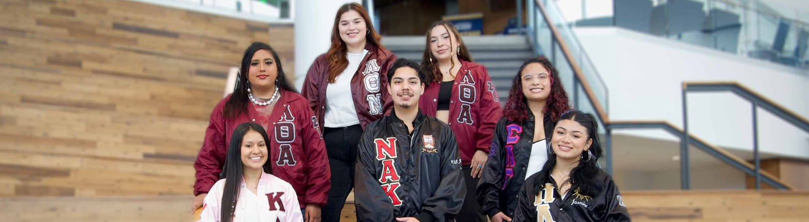 A group of MGC members pose on a set of bleachers.