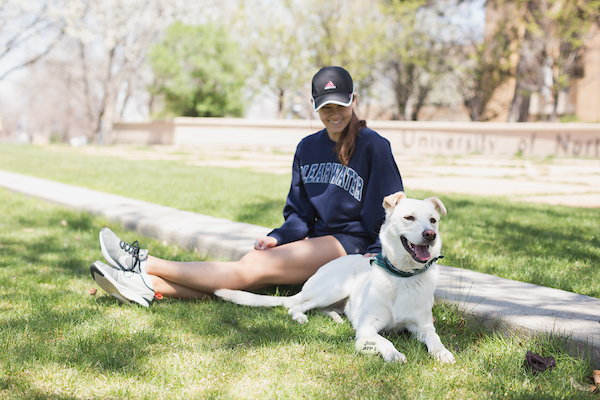 A UNC student with her dog outside