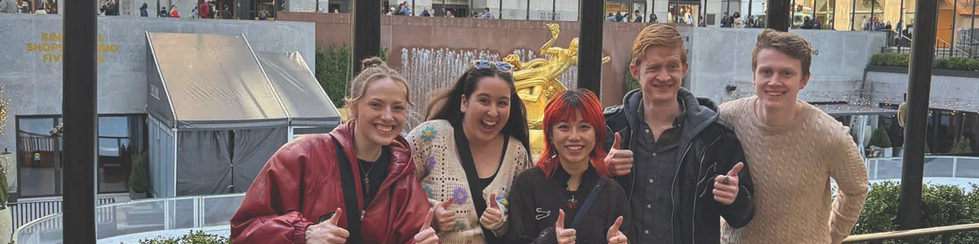 Students smiling in Rockefeller Plaza.