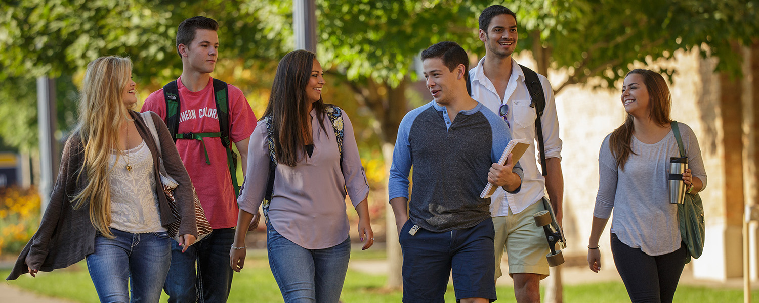 students studying on campus lawn